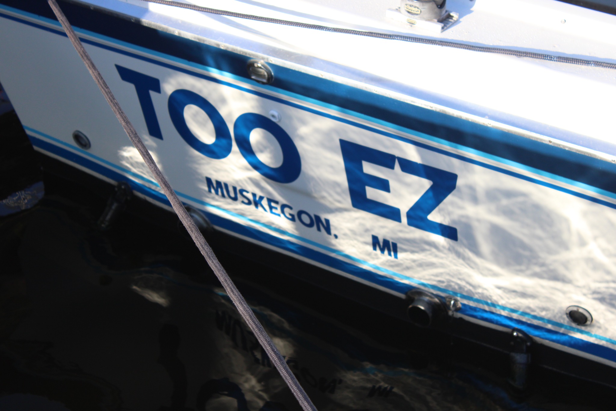 A fishing boat hull with registration number and Muskegon, MI marking.